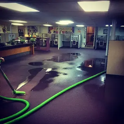 Standing water across an office floor with an extraction hose in Canoga Park