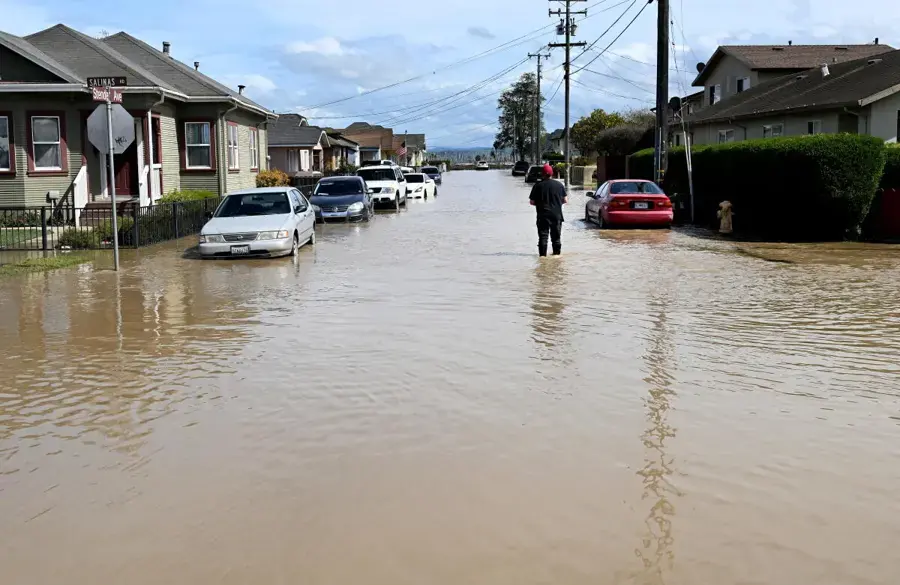 Storm water flooding a residential street during a winter storm
