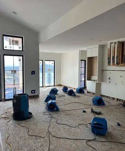 Air movers and a dehumidifier drying an opened room during structural drying in Canoga Park